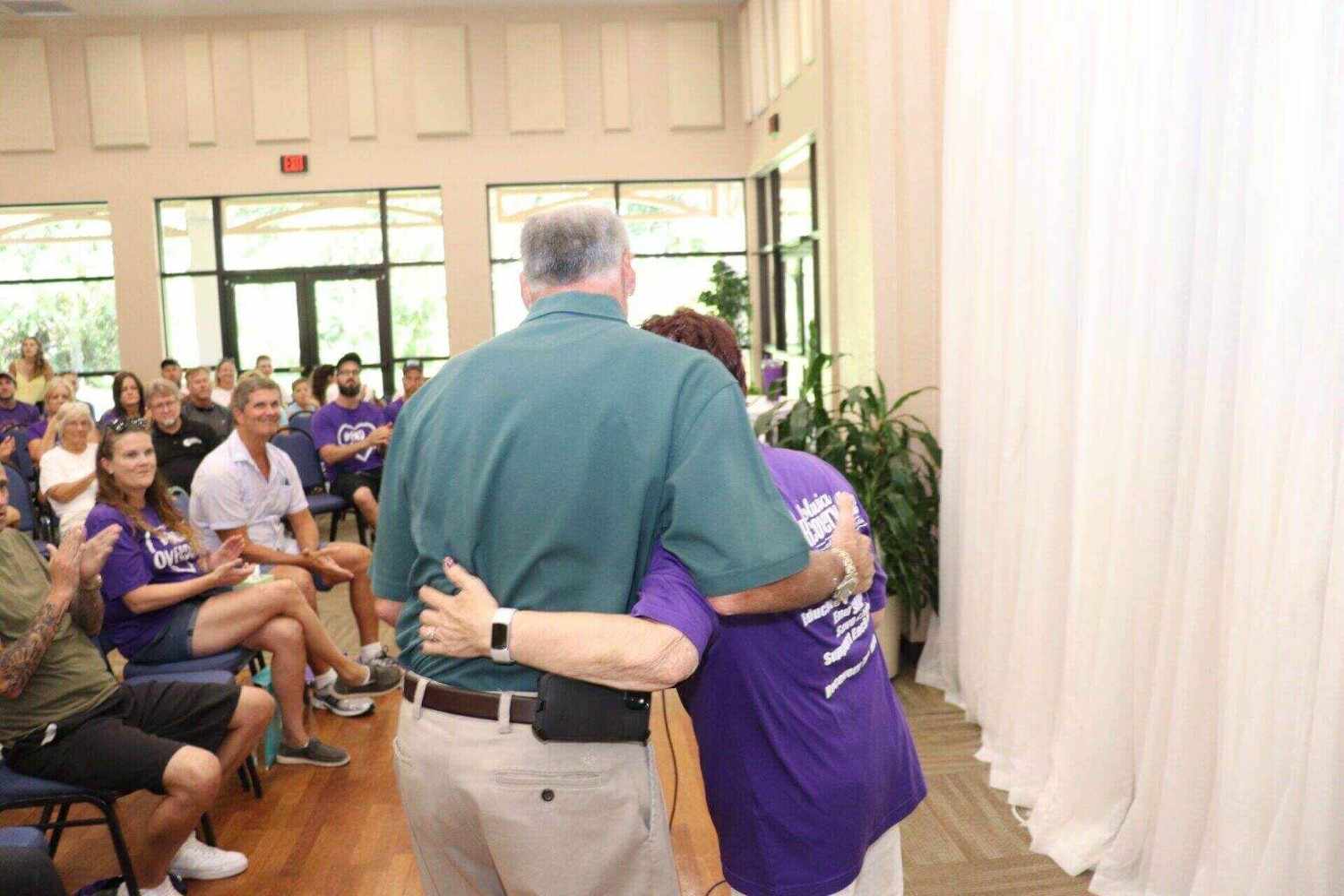 volusia conference Two people hugging each other